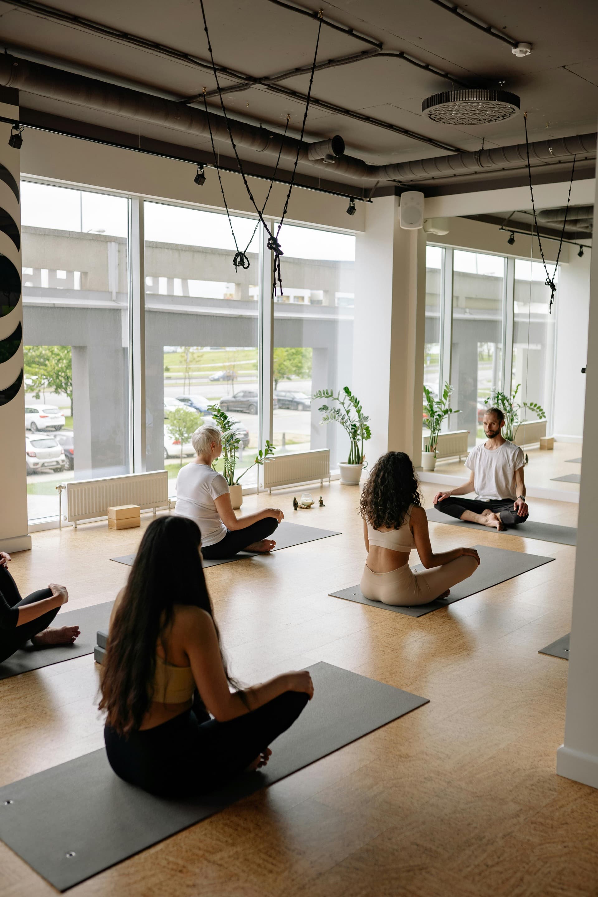 Yoga class in a bright modern studio — businesses of all kinds use Bookr